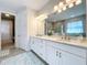 Elegant bathroom with double vanity, large mirror, and soaking tub at 341 Villoresi Blvd, Nokomis, FL 34275