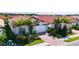 Single-Gathering home with red tile roof, white garage door, and landscaped yard at 341 Villoresi Blvd, Nokomis, FL 34275