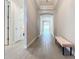 Bright entry hall with tile floors and bench at 341 Villoresi Blvd, Nokomis, FL 34275