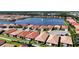 Aerial view of a lakefront community with numerous houses and lush greenery at 341 Villoresi Blvd, Nokomis, FL 34275