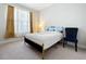 Bright bedroom with a queen-size bed and large window at 341 Villoresi Blvd, Nokomis, FL 34275