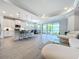 Open concept kitchen and living room with white cabinets and island at 341 Villoresi Blvd, Nokomis, FL 34275