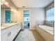 Elegant bathroom with double vanity and soaking tub at 341 Villoresi Blvd, Nokomis, FL 34275