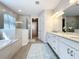 Spa-like bathroom with a soaking tub, walk-in shower, and double vanity at 341 Villoresi Blvd, Nokomis, FL 34275