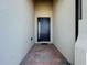 Home entryway with a dark blue door and brick-paved walkway at 341 Villoresi Blvd, Nokomis, FL 34275
