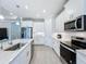 Modern kitchen with stainless steel appliances and white cabinets at 341 Villoresi Blvd, Nokomis, FL 34275