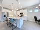 Modern kitchen with white cabinets, quartz countertops, and island at 341 Villoresi Blvd, Nokomis, FL 34275