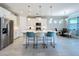 Modern kitchen with white cabinets, quartz countertops and island at 341 Villoresi Blvd, Nokomis, FL 34275