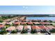 Aerial view of a community with lakefront properties and numerous houses at 341 Villoresi Blvd, Nokomis, FL 34275