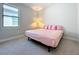 Serene bedroom with a king-size bed and soft pink bedding at 341 Villoresi Blvd, Nokomis, FL 34275