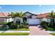 House exterior with a brick driveway and landscaping at 341 Villoresi Blvd, Nokomis, FL 34275