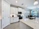 Modern kitchen featuring white cabinets, stainless steel appliances and an island at 341 Villoresi Blvd, Nokomis, FL 34275