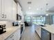 Modern kitchen with white cabinets, quartz countertops and stainless steel appliances at 341 Villoresi Blvd, Nokomis, FL 34275