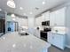 Modern kitchen with white cabinets and a large quartz island at 341 Villoresi Blvd, Nokomis, FL 34275