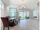 Bright dining room with glass table and sliding doors to backyard at 341 Villoresi Blvd, Nokomis, FL 34275