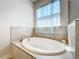 Relaxing bathroom with a soaking tub and window at 341 Villoresi Blvd, Nokomis, FL 34275