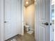 Small powder room with toilet and pedestal sink at 341 Villoresi Blvd, Nokomis, FL 34275