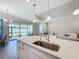 Kitchen island with sink and stainless steel faucet at 341 Villoresi Blvd, Nokomis, FL 34275