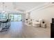Open living room with hardwood floors and large windows at 341 Villoresi Blvd, Nokomis, FL 34275