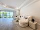 Spacious living room with large windows, beige sectional sofa and a glass coffee table at 341 Villoresi Blvd, Nokomis, FL 34275
