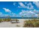 Peaceful beach scene with picnic table, sea oats, and ocean view at 8993 Bantry Bay Blvd, Englewood, FL 34224