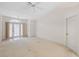 Open living room with neutral walls and carpet flooring at 8993 Bantry Bay Blvd, Englewood, FL 34224