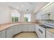 Bright kitchen with white cabinets and a view of the dining area at 8993 Bantry Bay Blvd, Englewood, FL 34224