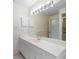 Bathroom with vanity, large mirror, and a shower at 8993 Bantry Bay Blvd, Englewood, FL 34224