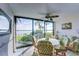 Bright sunroom with water views and wicker furniture at 8911 Midnight Pass Rd # 110, Sarasota, FL 34242