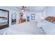 Main bedroom with king bed, en-suite bathroom, and laundry access at 8911 Midnight Pass Rd # 110, Sarasota, FL 34242