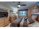 Bedroom with large bed, dresser and TV at 8911 Midnight Pass Rd # 110, Sarasota, FL 34242