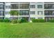 Building exterior showcasing lush landscaping and balconies at 8911 Midnight Pass Rd # 110, Sarasota, FL 34242