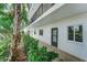 Condo building exterior with landscaping at 8911 Midnight Pass Rd # 110, Sarasota, FL 34242