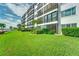 Building exterior with lush landscaping and water views at 8911 Midnight Pass Rd # 110, Sarasota, FL 34242