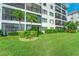 Building exterior with lush landscaping and balconies, near the water at 8911 Midnight Pass Rd # 110, Sarasota, FL 34242