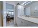 Bathroom with a vanity, toilet, and access to a bedroom at 8911 Midnight Pass Rd # 110, Sarasota, FL 34242