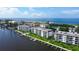 Aerial view of waterfront community with boats and lush landscaping at 8911 Midnight Pass Rd # 110, Sarasota, FL 34242