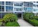Elegant condo entrance with lush landscaping, a well-lit walkway, and a distinguished building sign at 555 S Gulfstream Ave # 804, Sarasota, FL 34236