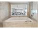 Spa-like bathroom with a soaking tub and bay view at 555 S Gulfstream Ave # 804, Sarasota, FL 34236