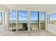 Sunroom with sliding glass doors offering panoramic water views at 555 S Gulfstream Ave # 804, Sarasota, FL 34236