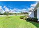 Backyard view of home, showcasing lush lawn and landscaping at 7758 Ridgelake Cir, Bradenton, FL 34203