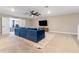 Game room with blue sectional couch and large flat-screen TV at 16208 Foxtail Ct, Punta Gorda, FL 33982