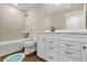 Modern bathroom with white vanity, tile flooring, and a relaxing bathtub at 16208 Foxtail Ct, Punta Gorda, FL 33982