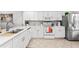 Modern kitchen boasting white cabinets and stainless steel appliances at 6050 28Th W St # 14B, Bradenton, FL 34207