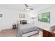 Cozy bedroom with gray bedding and ceiling fan at 6050 28Th W St # 14B, Bradenton, FL 34207