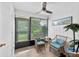 Bright sunroom with wicker chairs and large windows at 6050 28Th W St # 14B, Bradenton, FL 34207
