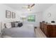 Main bedroom with gray bedding and ceiling fan at 6050 28Th W St # 14B, Bradenton, FL 34207