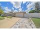 House exterior featuring a two-car garage, paved driveway, and basketball hoop at 3607 22Nd W Ave, Bradenton, FL 34205