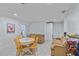 Casual dining area with wood table and chairs, adjacent to a living area at 3607 22Nd W Ave, Bradenton, FL 34205