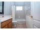 Clean bathroom with tub shower combo, wood vanity, and updated fixtures at 13814 Nighthawk Ter, Lakewood Ranch, FL 34202